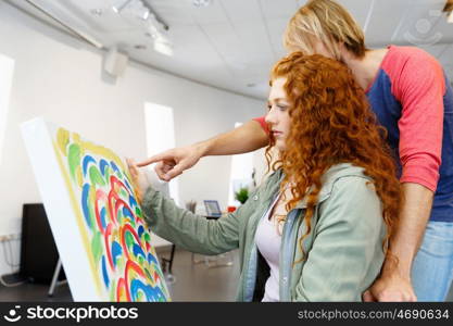 Young caucasian couple standing in a gallery and contemplating artwork. Young caucasian couple standing in a gallery and contemplating abstract artwork