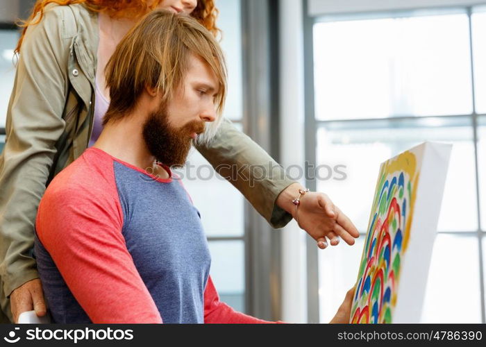 Young caucasian couple standing in a gallery and contemplating artwork. Young caucasian couple standing in a gallery and contemplating abstract artwork