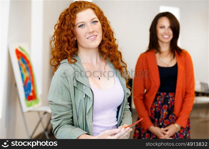 Young caucasian couple standing in a gallery and contemplating artwork. two young women in a gallery and contemplating abstract artwork