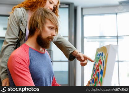 Young caucasian couple standing in a gallery and contemplating artwork. Young caucasian couple standing in a gallery and contemplating abstract artwork