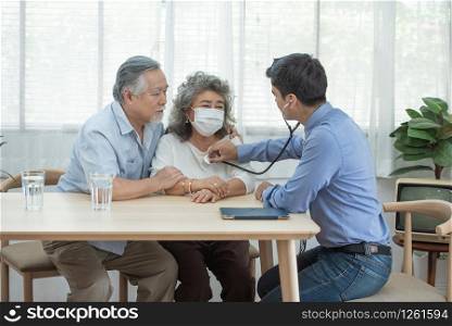 Young caucasian doctor check up with senior elderly old asian female patient about disease symptom, elderly health check up.Medicine, age, support, health care and people concept