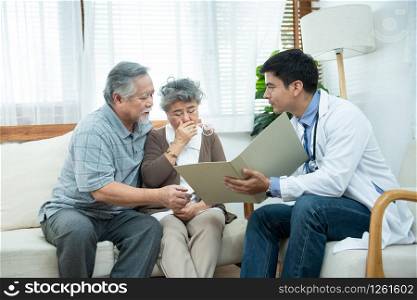 Young caucasian doctor man talking result of examination on file folder to senior elderly old asian woman with old man take care her beside.healthcare and medical concept.