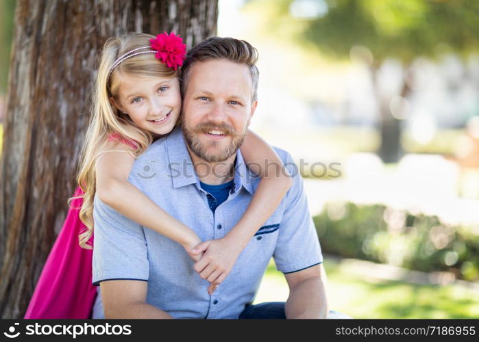 Young Caucasian Father And Daughter Portrait At The Park.