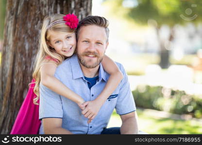 Young Caucasian Father And Daughter Portrait At The Park.