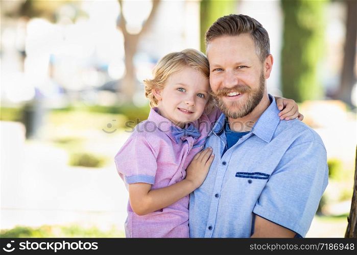 Young Caucasian Father And Son Portrait At The Park.