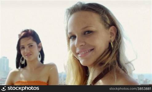 Young caucasian female couple looking at camera and smiling