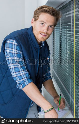 young caucasian handsome smiling man taking notes before action