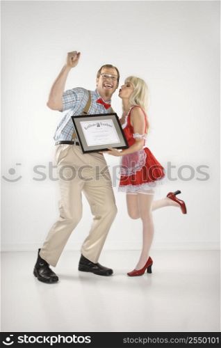 Young Caucasian man cheering and receiving certificate from young woman.