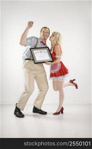 Young Caucasian man cheering and receiving certificate from young woman.