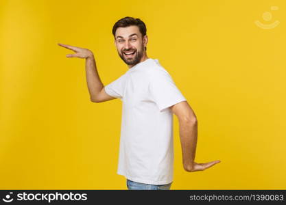 Young caucasian man isolated on yellow dancing and having fun. Young caucasian man isolated on yellow dancing and having fun.