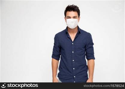 Young caucasian man wearing face mask to protect from COVID-19 and looking at camera isolated on white background
