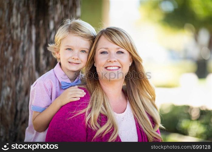 Young Caucasian Mother And Daughter Portrait At The Park.