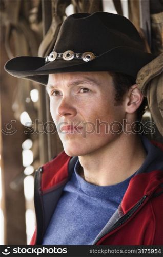 Young Caucasian nam wearing cowboy hat.