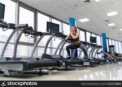Young caucasian sporty Woman On Running Machine In Gym. Young sporty Woman On Running Machine In Gym