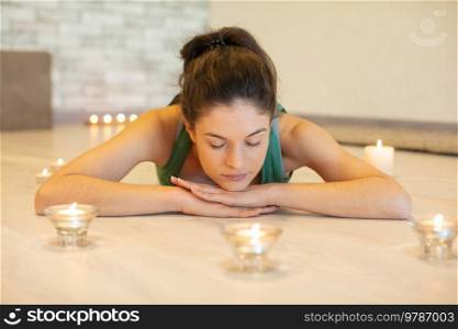 young caucasian woman doing yoga on sofa at home