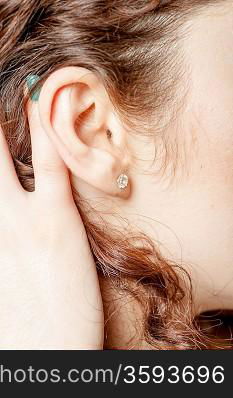 Young caucasian woman ear closeup.