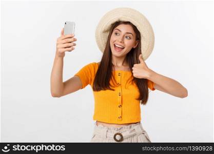 Young Caucasian woman enjoying the selfie with herself isolated on white background summer travel concept. Young Caucasian woman enjoying the selfie with herself isolated on white background summer travel concept.