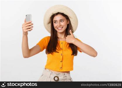 Young Caucasian woman enjoying the selfie with herself isolated on white background summer travel concept. Young Caucasian woman enjoying the selfie with herself isolated on white background summer travel concept.
