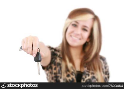 Young caucasian woman holding car key. Image with shallow depth of field. The key is in focus.