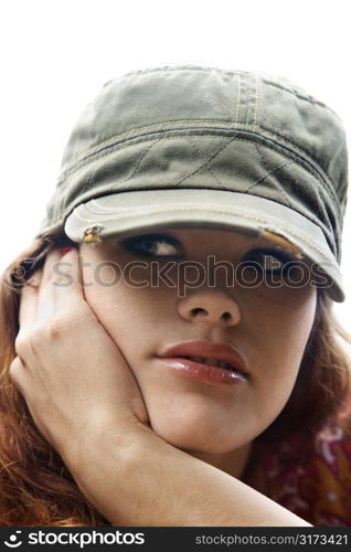 Young Caucasian woman wearing hat and resting head on hand.