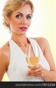 Young celebrating woman in white dress with a glass of champagne . Beautiful model portrait