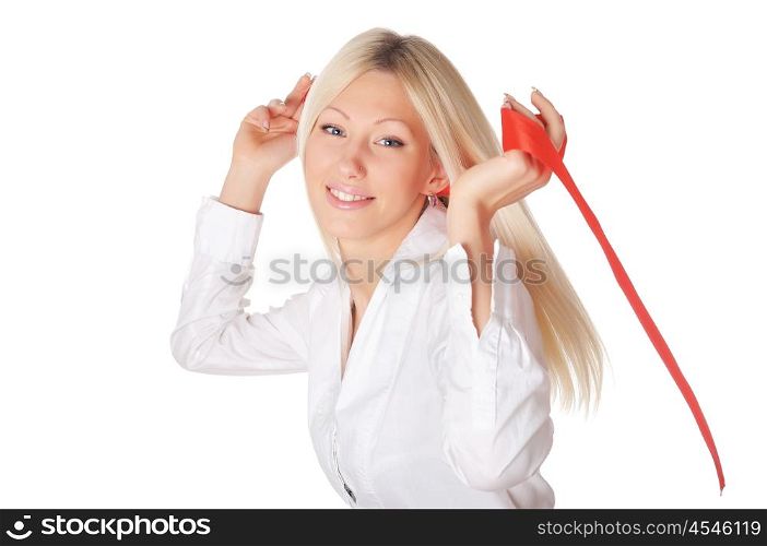 Young charming blonde in a white shirt plays with a red ribbon in the hands