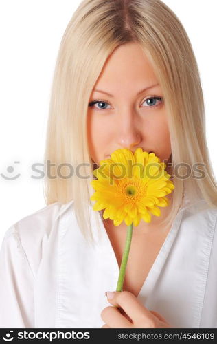 Young charming blonde is playing with a yellow flower isolated on white background