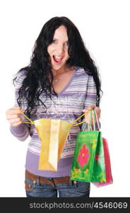 young charming brunette in a lilac sweater and jeans with shopping bags in their hands