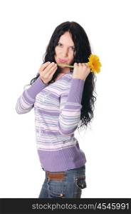 young charming brunette in a sweater and jeans with a yellow flower in the hands