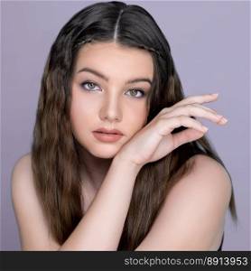 Young charming brunette sweet smiling, posing hand gesture for beauty and cosmetic concept advertising. Beautiful young  girl with perfect long hair and flawless clean fresh skin.. Young charming brunette posing hand gesture for beauty and cosmetic concept.
