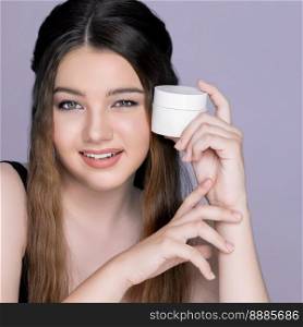 Young charming girl hold mockup moisturizer skincare cream jar or container for copyspace advertising. Photo of beautiful and attractive girl with perfect makeup for beauty concept.. Young charming girl hold mockup moisturizer skincare cream jar for advertising.