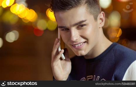 Young charming guy talking on the phone