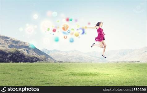 Young cheerful lady in red dress jumping high