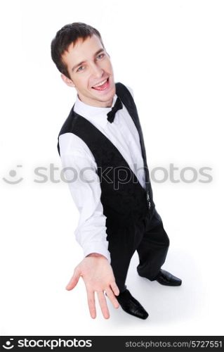 Young cheerful male waiter showing something - isolated on white