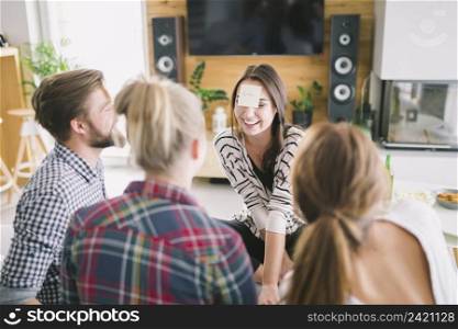 young cheerful people guessing cards