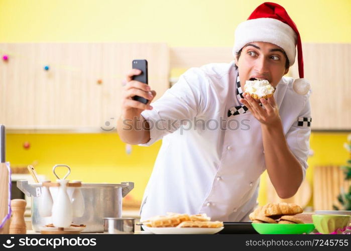 Young chef husband working in kitchen at Christmas eve 