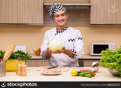 Young chef working in the kitchen