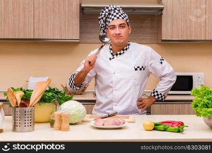 Young chef working in the kitchen