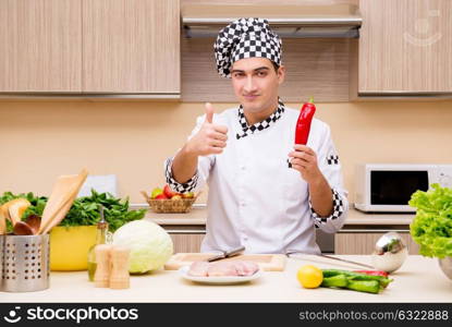 Young chef working in the kitchen