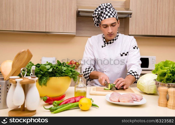 Young chef working in the kitchen