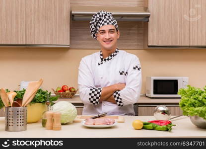 Young chef working in the kitchen