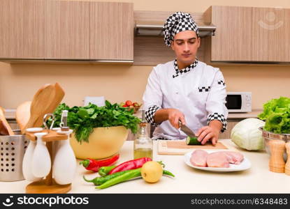 Young chef working in the kitchen