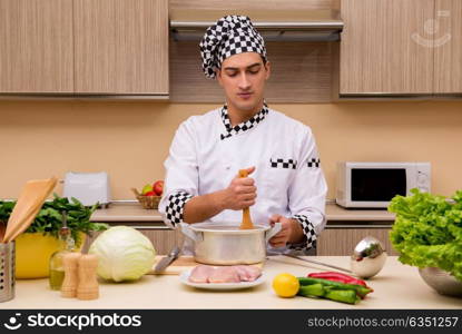 Young chef working in the kitchen