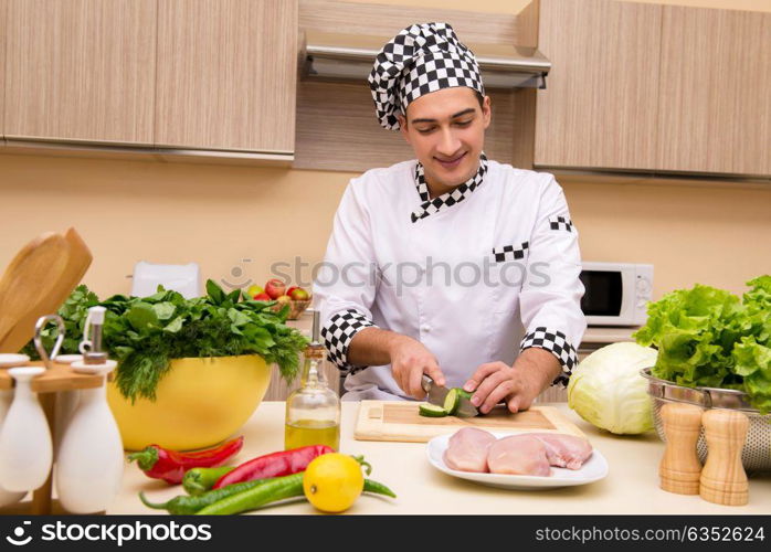 Young chef working in the kitchen