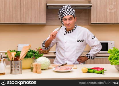 Young chef working in the kitchen