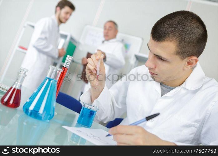 young chemist makes chemical test in the laboratory