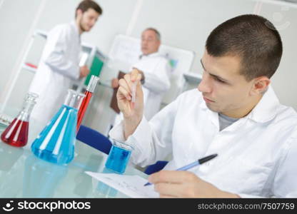 young chemist makes chemical test in the laboratory