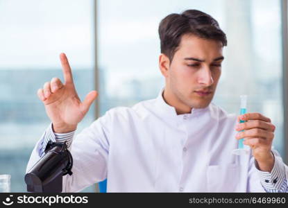 Young chemist pressing virtual buttons in lab