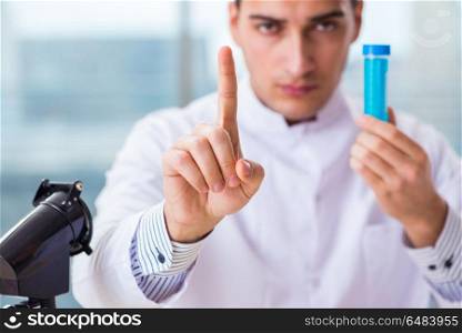 Young chemist pressing virtual buttons in lab