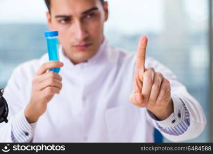 Young chemist pressing virtual buttons in lab